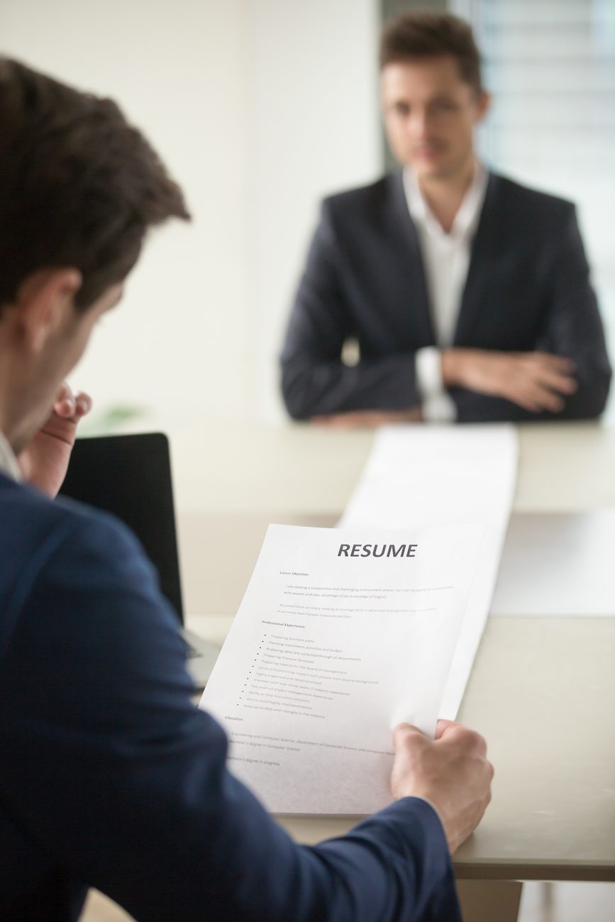 Recruiter reviewing a candidate's resume in an interview